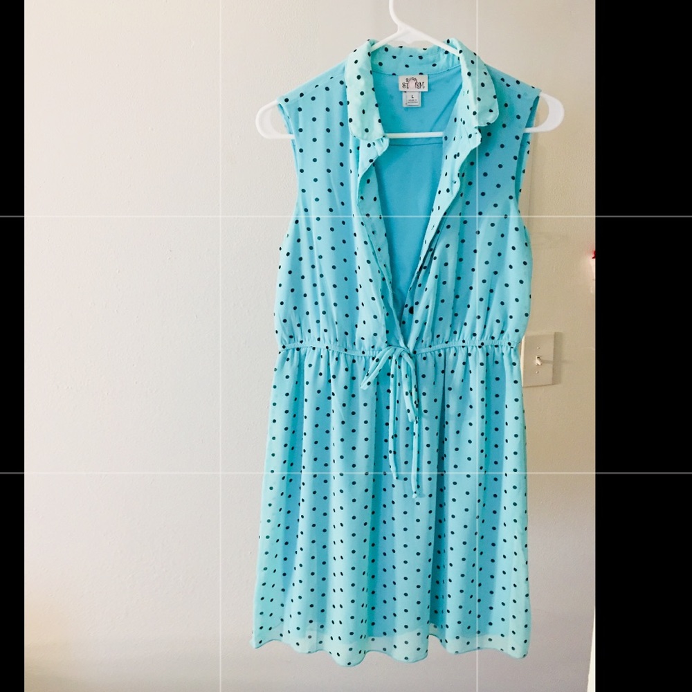 A mint green polka dotted tie dress